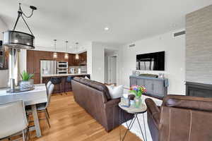 Living area with light wood-style floors and recessed lighting