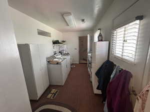 Hallway featuring washer and clothes dryer
