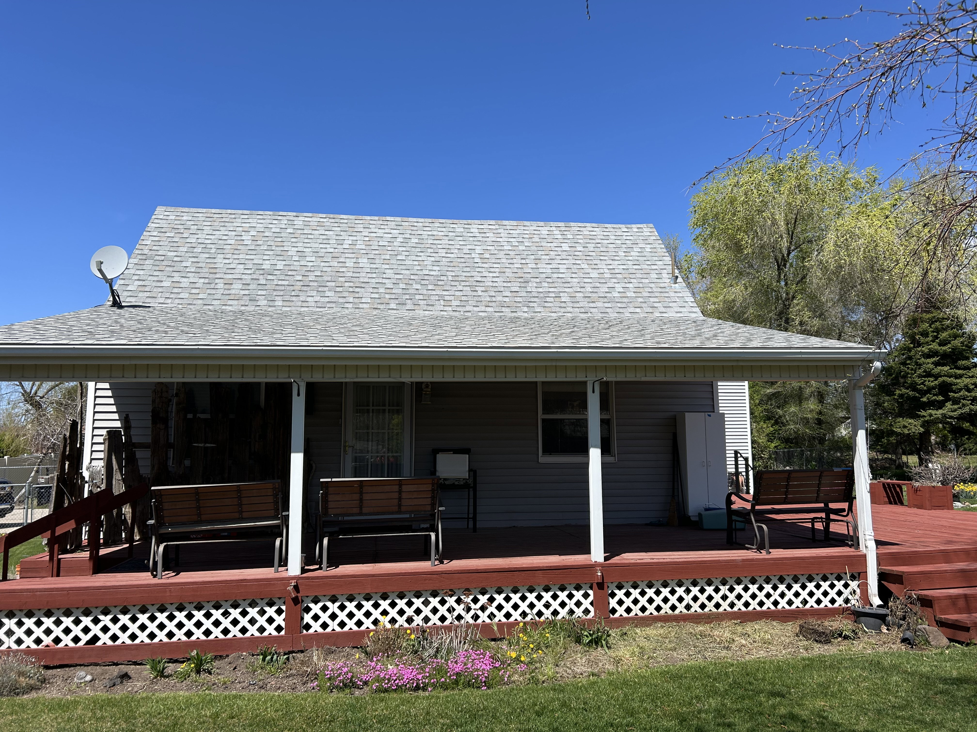 Back of property featuring roof with shingles
