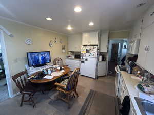 Dining room featuring ornamental molding and recessed lighting