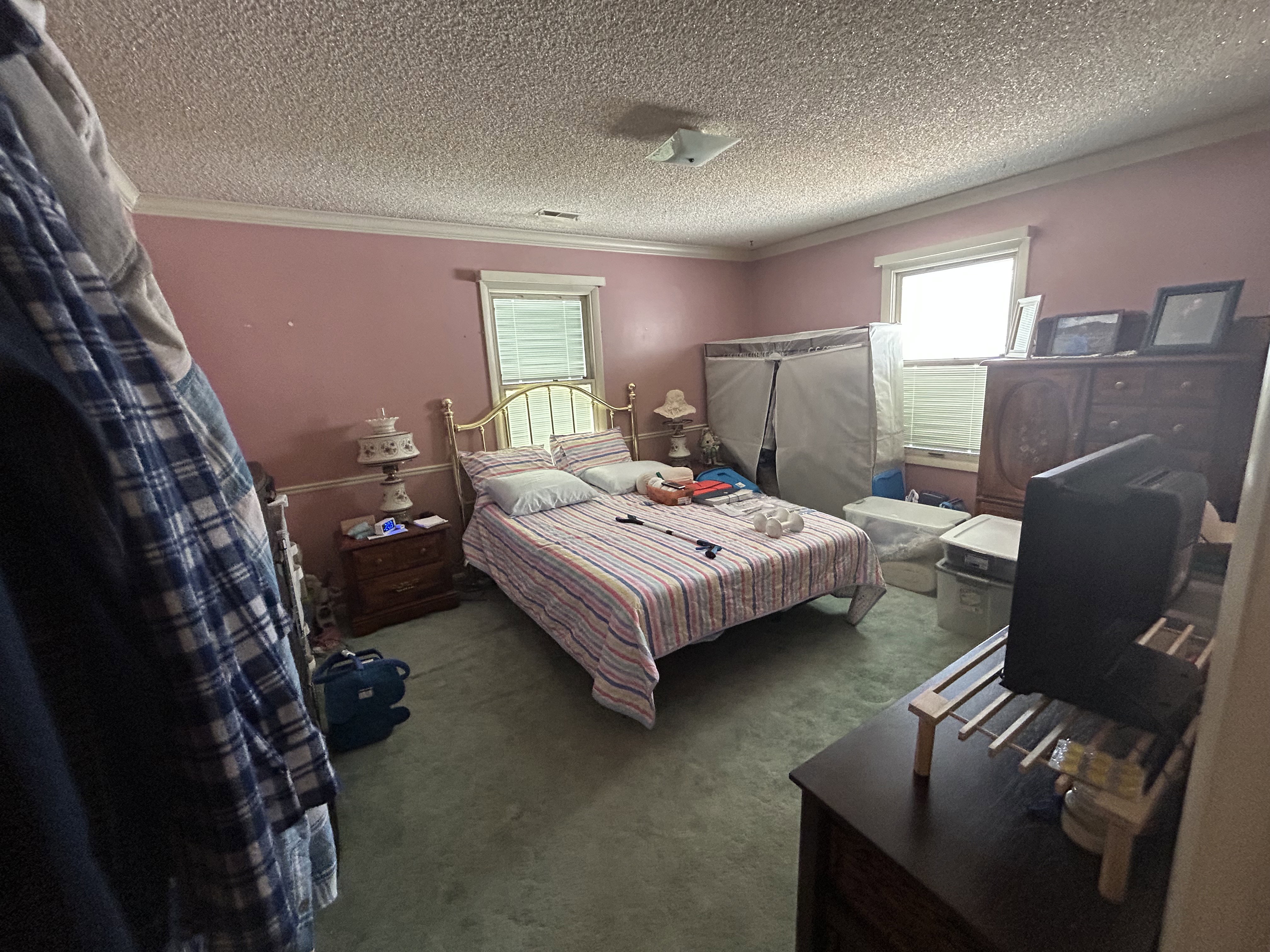 Bedroom with carpet flooring, a textured ceiling, and ornamental molding