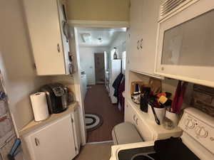 Bathroom with washer / dryer and tile patterned flooring