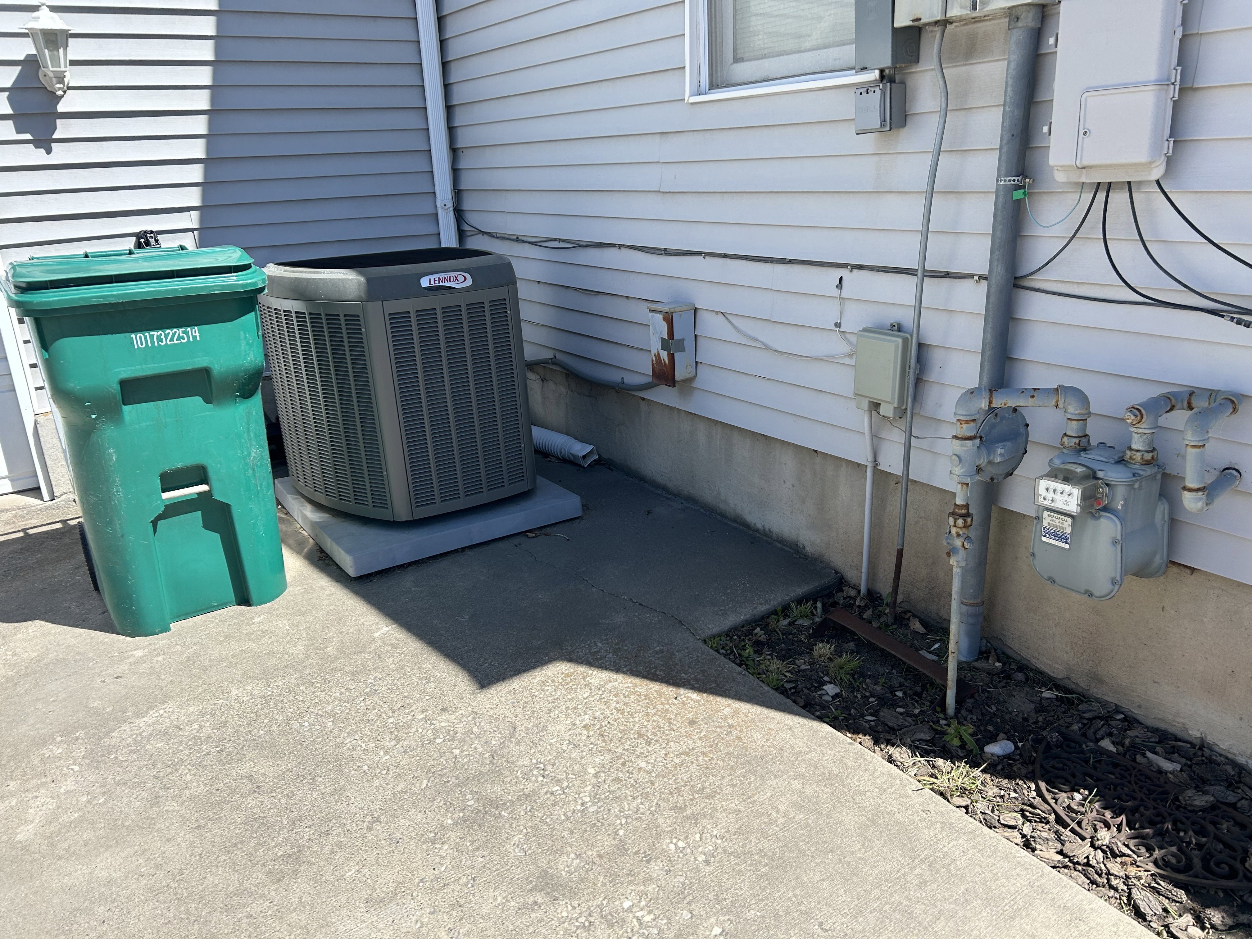 Exterior view of central AC unit and gas meter