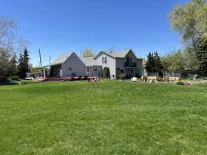 Back of house featuring a yard