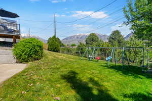 View of yard with a playground and a mountain view
