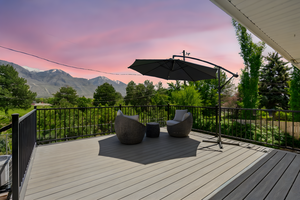 Deck at dusk featuring a mountain view