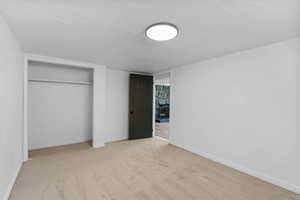 Unfurnished bedroom featuring carpet, a closet, and baseboards