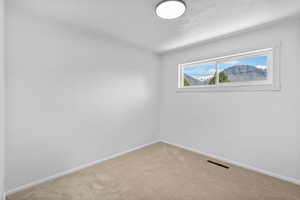 Empty room with carpet flooring and baseboards
