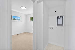 Washroom with electric dryer hookup, baseboards, and washer hookup