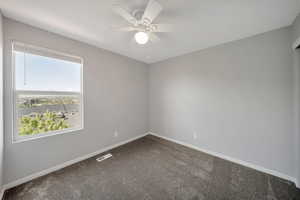 Bedroom with ceiling fan and views