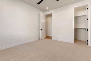 Unfurnished bedroom with recessed lighting, light colored carpet, baseboards, ceiling fan, and a closet