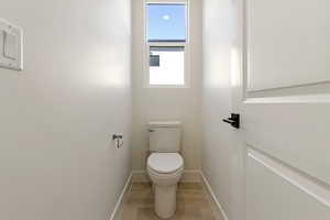Bathroom with toilet and baseboards