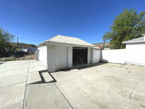 Detached garage featuring fence