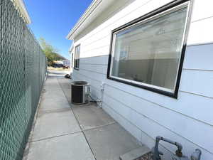 View of home's exterior with cooling unit and a patio