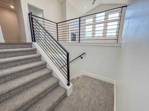 Stairs featuring carpet flooring, lofted ceiling, and recessed lighting