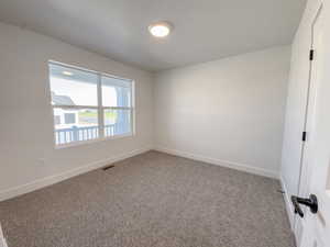 Spare room featuring carpet floors