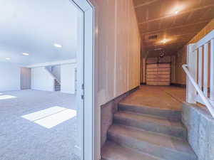 Stairway with carpet and recessed lighting