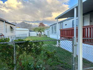Yard at dusk with a mountain view and a gate