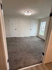 Unfurnished room featuring a textured ceiling and light wood-type flooring