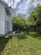View of green lawn featuring a patio area