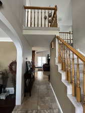 Staircase featuring arched walkways and baseboards
