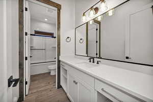 Bathroom featuring vanity, light wood-style flooring, and bathtub / shower combination