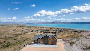 Aerial view of property and surrounding area featuring a water and mountain view