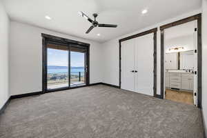 Unfurnished bedroom with access to exterior, light colored carpet, recessed lighting, a ceiling fan, and a closet