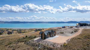 Aerial view of property and surrounding area with a water and mountain view