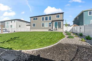 Rear view of house featuring entry steps and stucco siding
