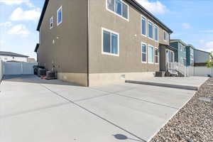Back of property featuring fence, a patio, RV parking, and stucco siding