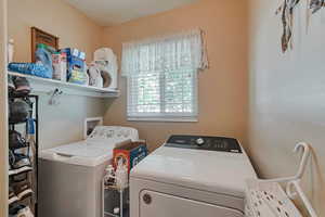 Laundry room featuring separate washer and dryer