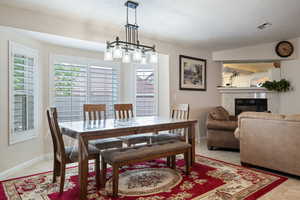 Dining space featuring a fireplace and baseboards