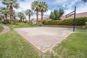 View of sport court with community basketball court and a lawn