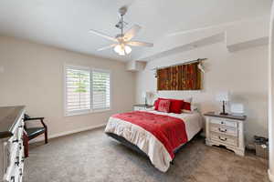 Bedroom with carpet, baseboards, and ceiling fan