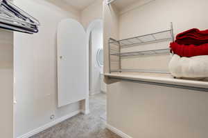 Washroom featuring light carpet and baseboards