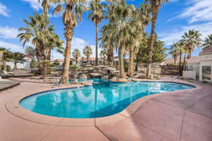 View of pool with a patio, fence, and a residential view