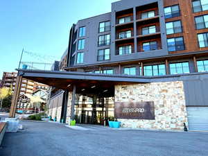 View of building exterior with valet parking