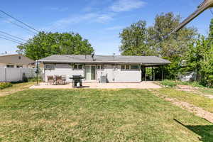 Rear view of property with a patio, central AC unit, and roof with shingles