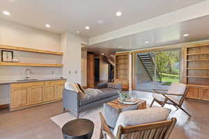Living room featuring recessed lighting and stairs