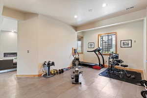 Exercise area with baseboards and recessed lighting