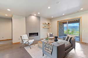Living room with recessed lighting, baseboards, and a tile fireplace