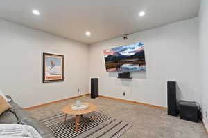 Living area with carpet, recessed lighting, and baseboards
