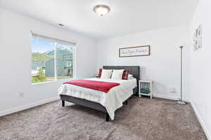 Carpeted bedroom with baseboards