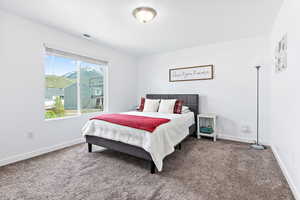 Carpeted bedroom featuring baseboards