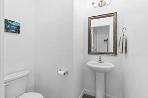 Bathroom with toilet and baseboards