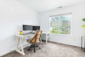 Carpeted office space featuring baseboards