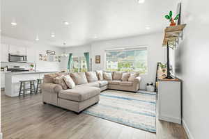 Living area featuring light wood-style floors and recessed lighting