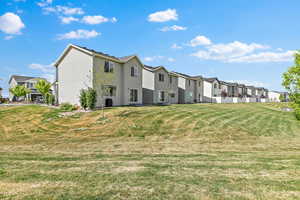 View of home's community with a residential view and a lawn