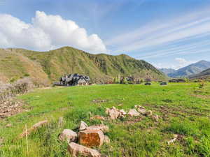 View of mountain backdrop featuring rural landscape